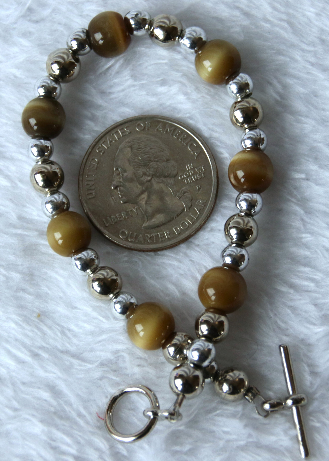 Bracelet of Brown Cat’s Eye Glass with silver colored beads, toggle closure