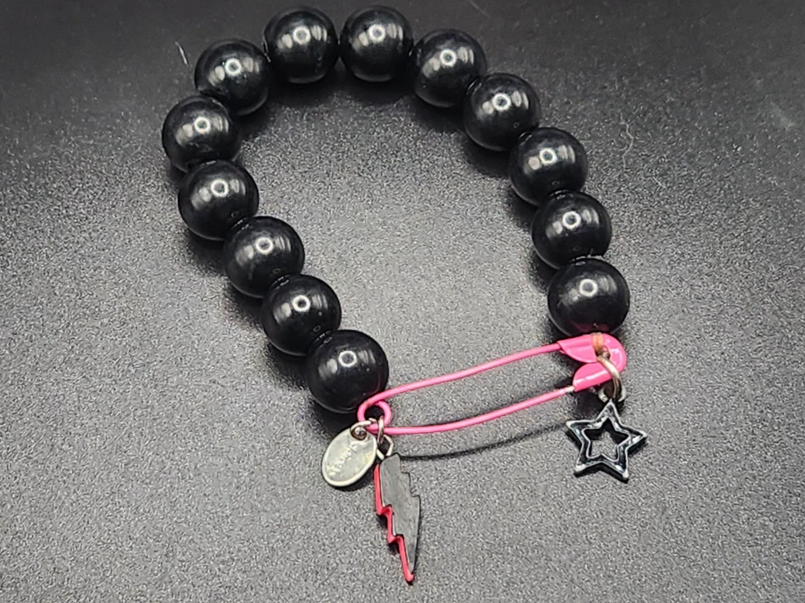 #0351 – Claire’s Black Beaded Stretch Bracelet Pink Safety Pin Lightning Bolt…