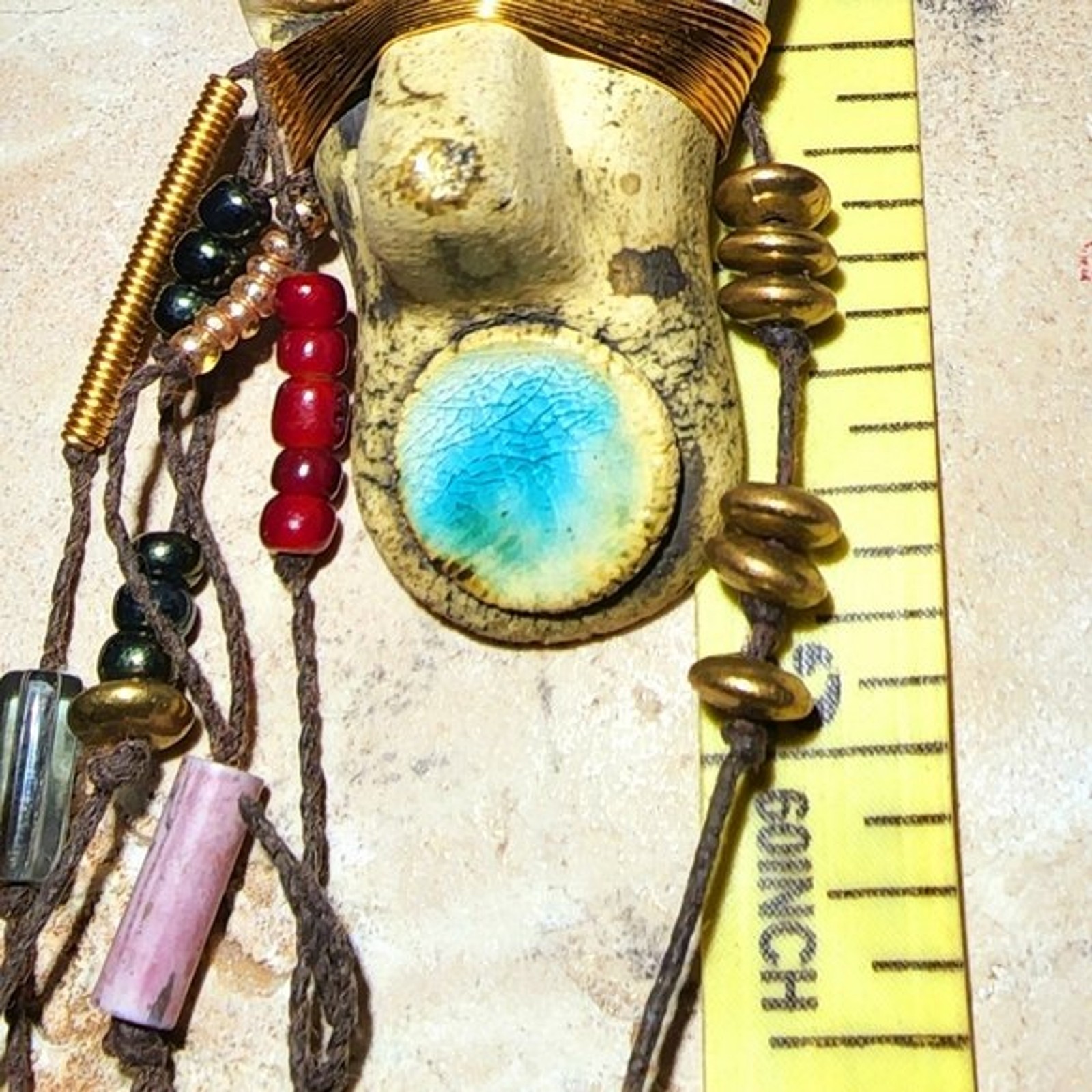 Abstract tribal brutalist face with locs like hair artisan brooch