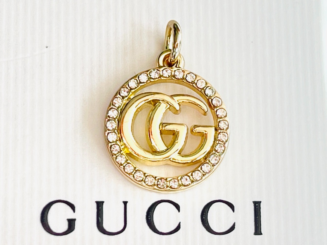 One Gucci Pendant rinestones stamped