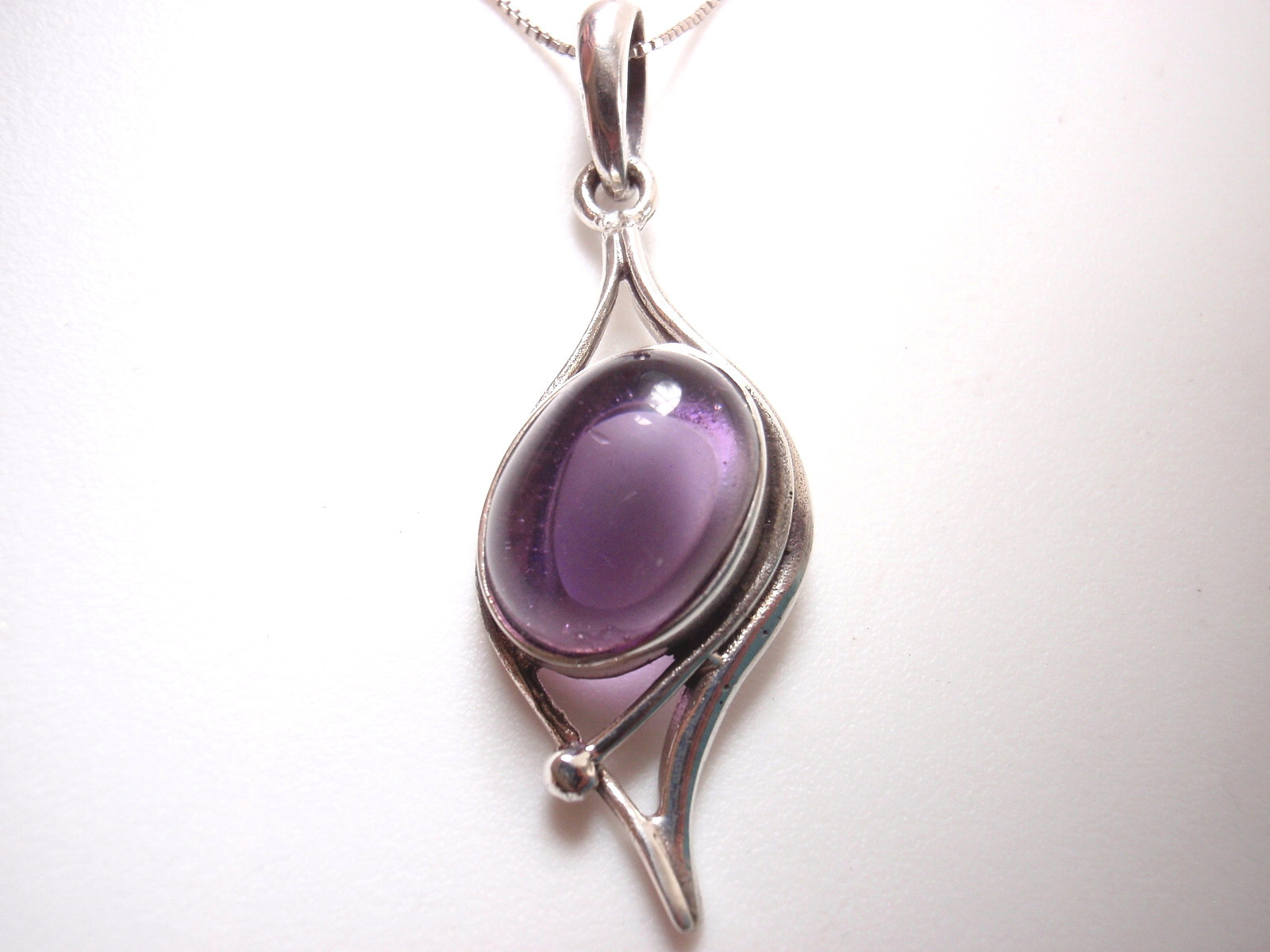 Simulated Amethyst Framed in Curves 925 Sterling Silver Pendant