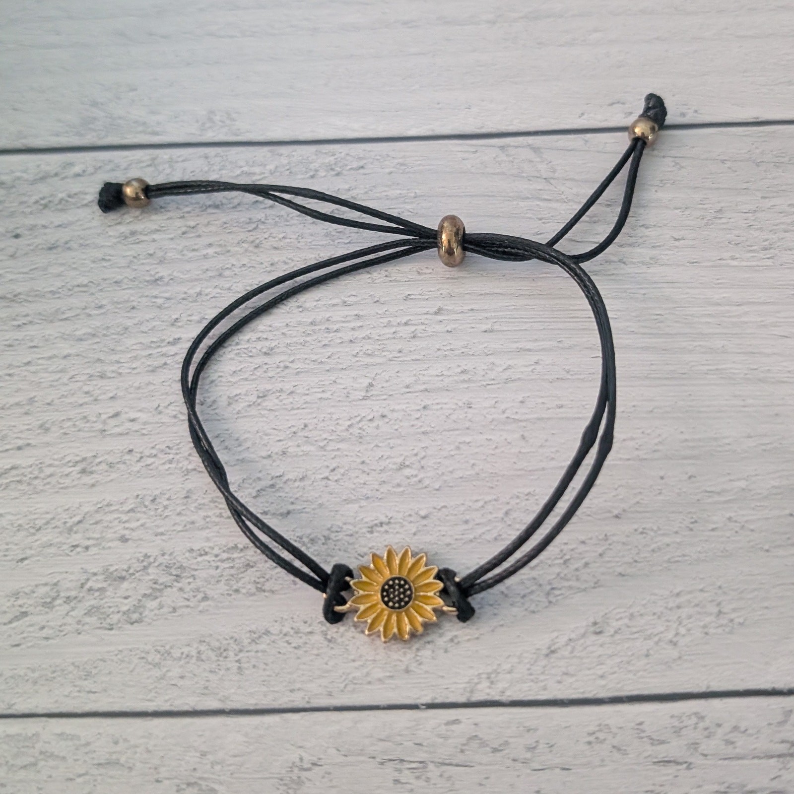 Black Adjustable Bracelet with Sunflower Charm – Fair Condition