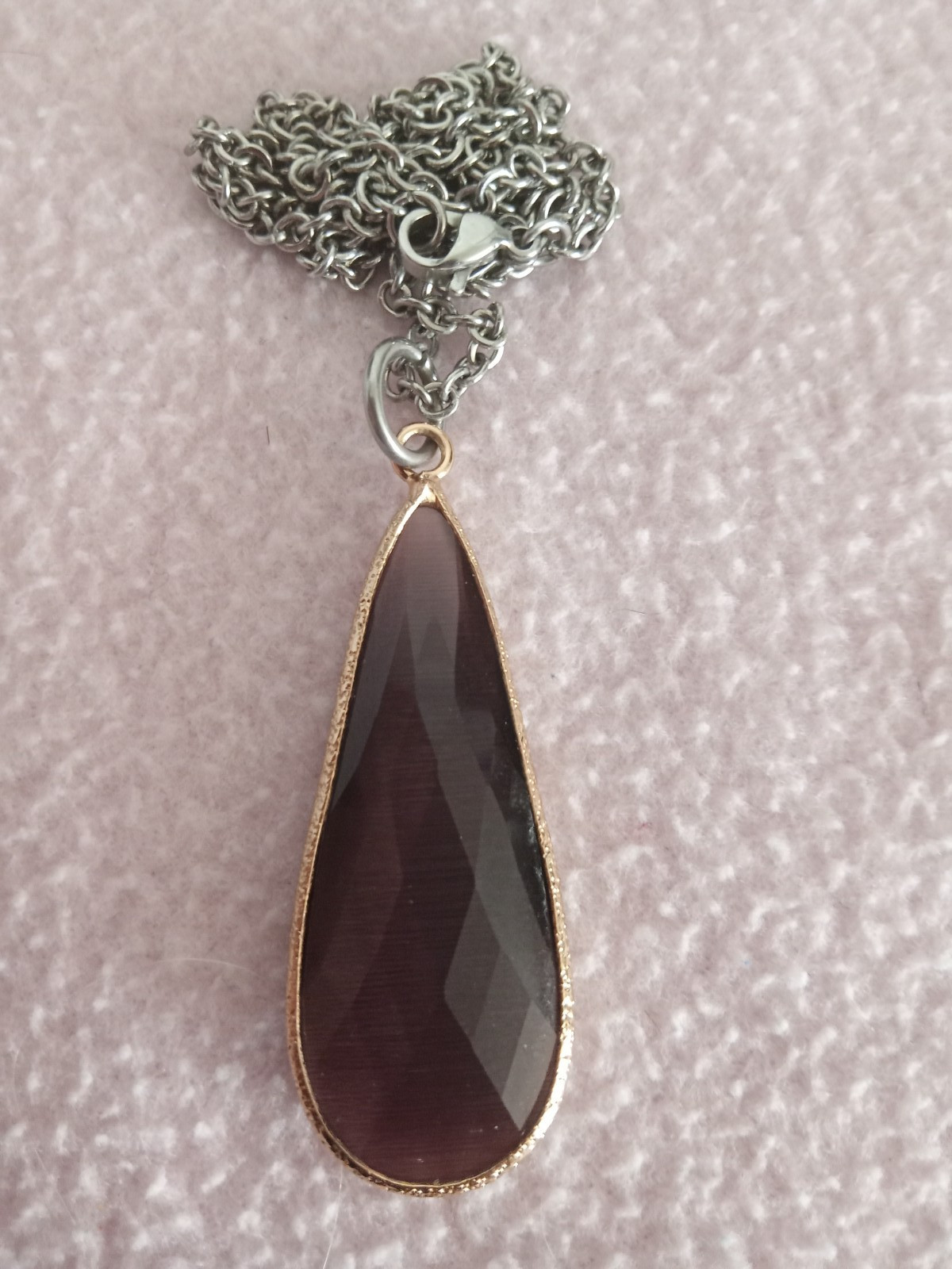 Faceted Purple Long Teardrop Stone Pentant framed in gold tone metal with chain