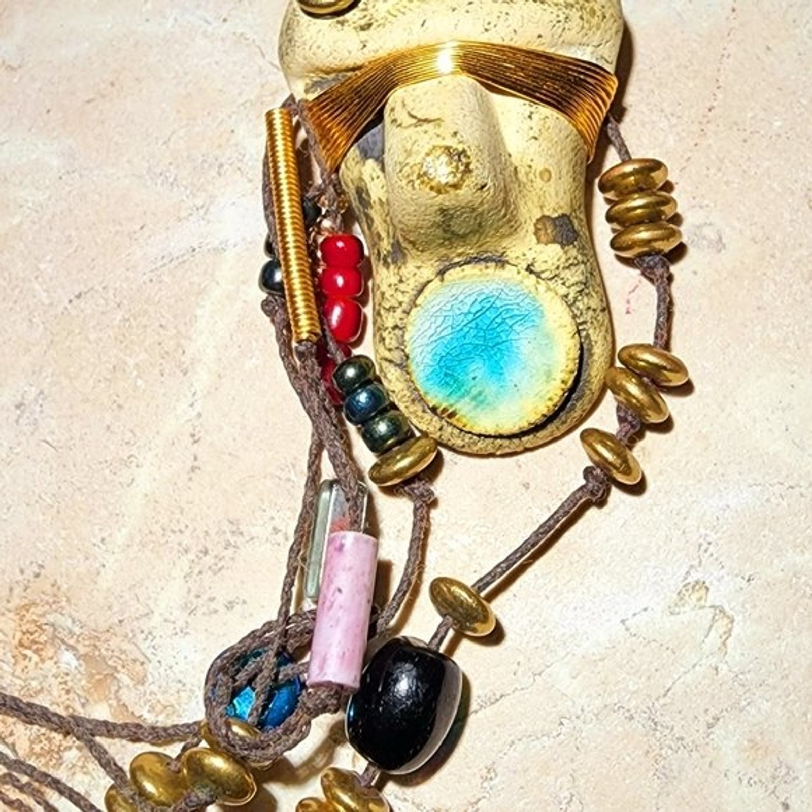 Abstract tribal brutalist face with locs like hair artisan brooch
