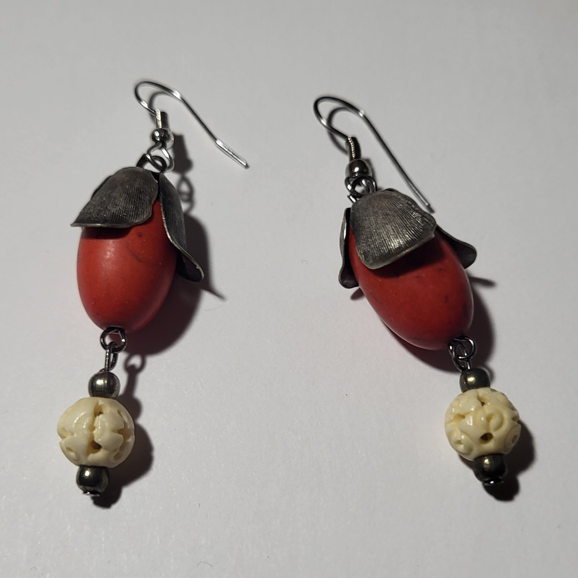 Handcrafted dangle earring featuring a large red coral Seed & Ivory Bead.