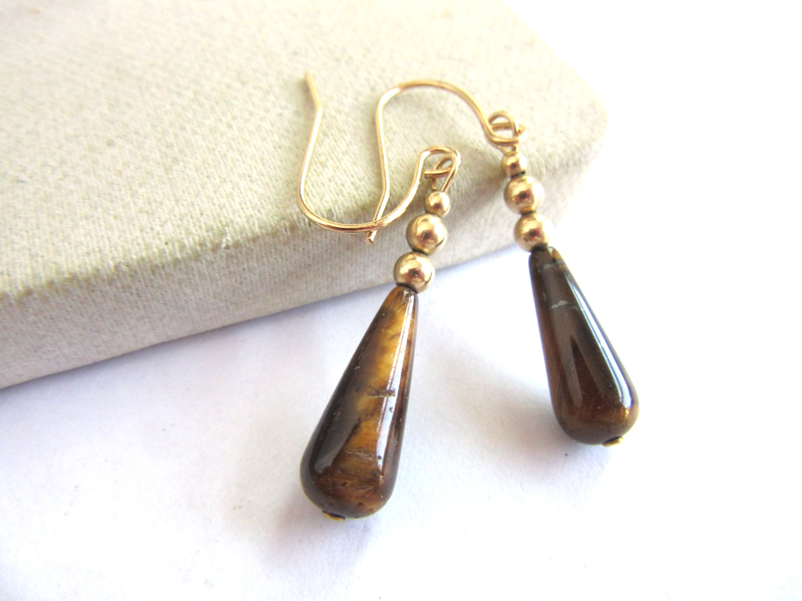 Gold tone hook pierced earrings with teardrop Tigers eye beads