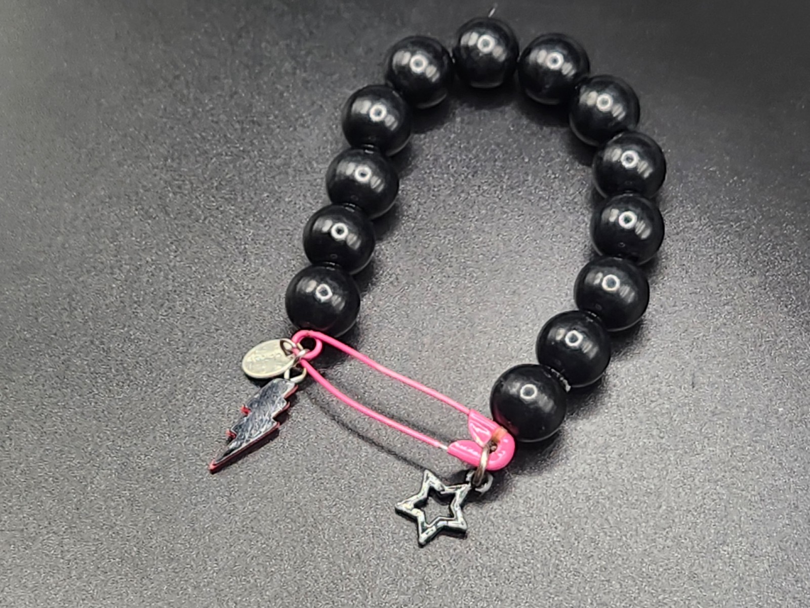#0351 – Claire’s Black Beaded Stretch Bracelet Pink Safety Pin Lightning Bolt…
