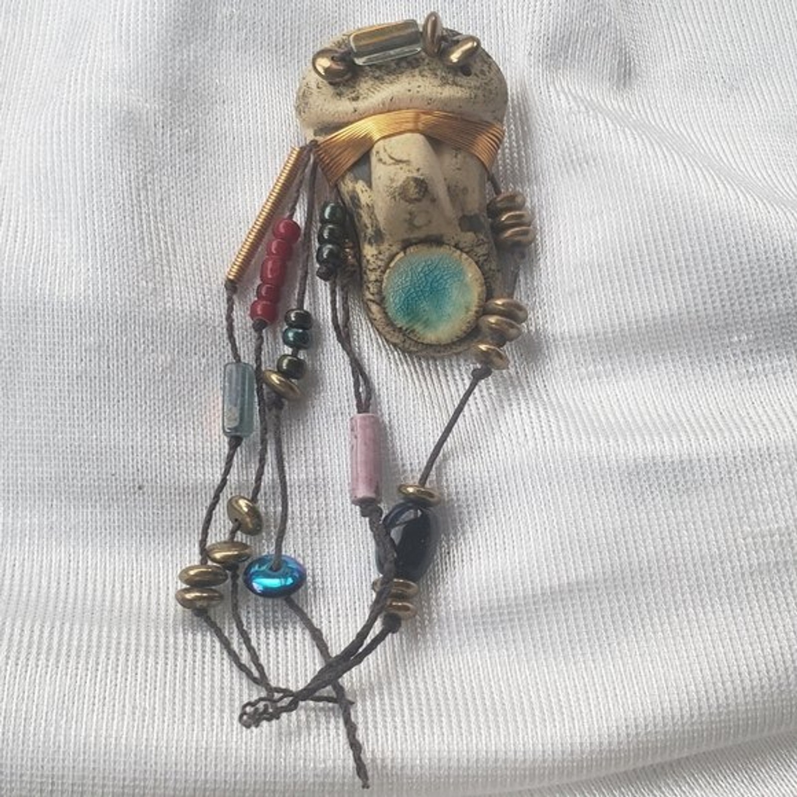 Abstract tribal brutalist face with locs like hair artisan brooch