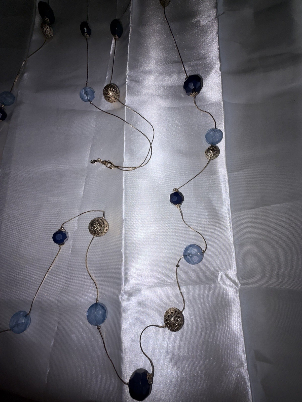 Premier Designs necklace features blue acrylic beads and gold spheres