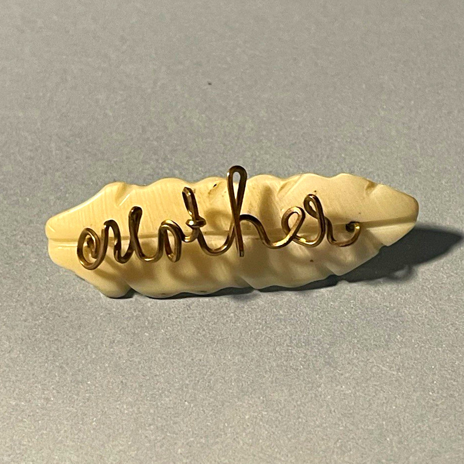 Beige Plastic Script “Clothes” Brooch Pin, Gold Tone Metal, Engraved