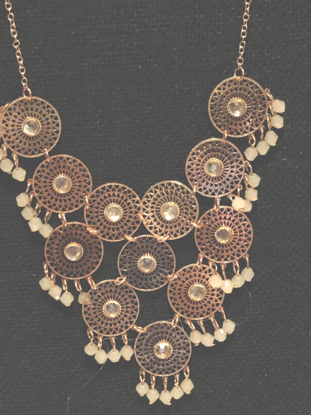 Charming Charlie’s pink rose tone filagree cha cha disc statement necklace