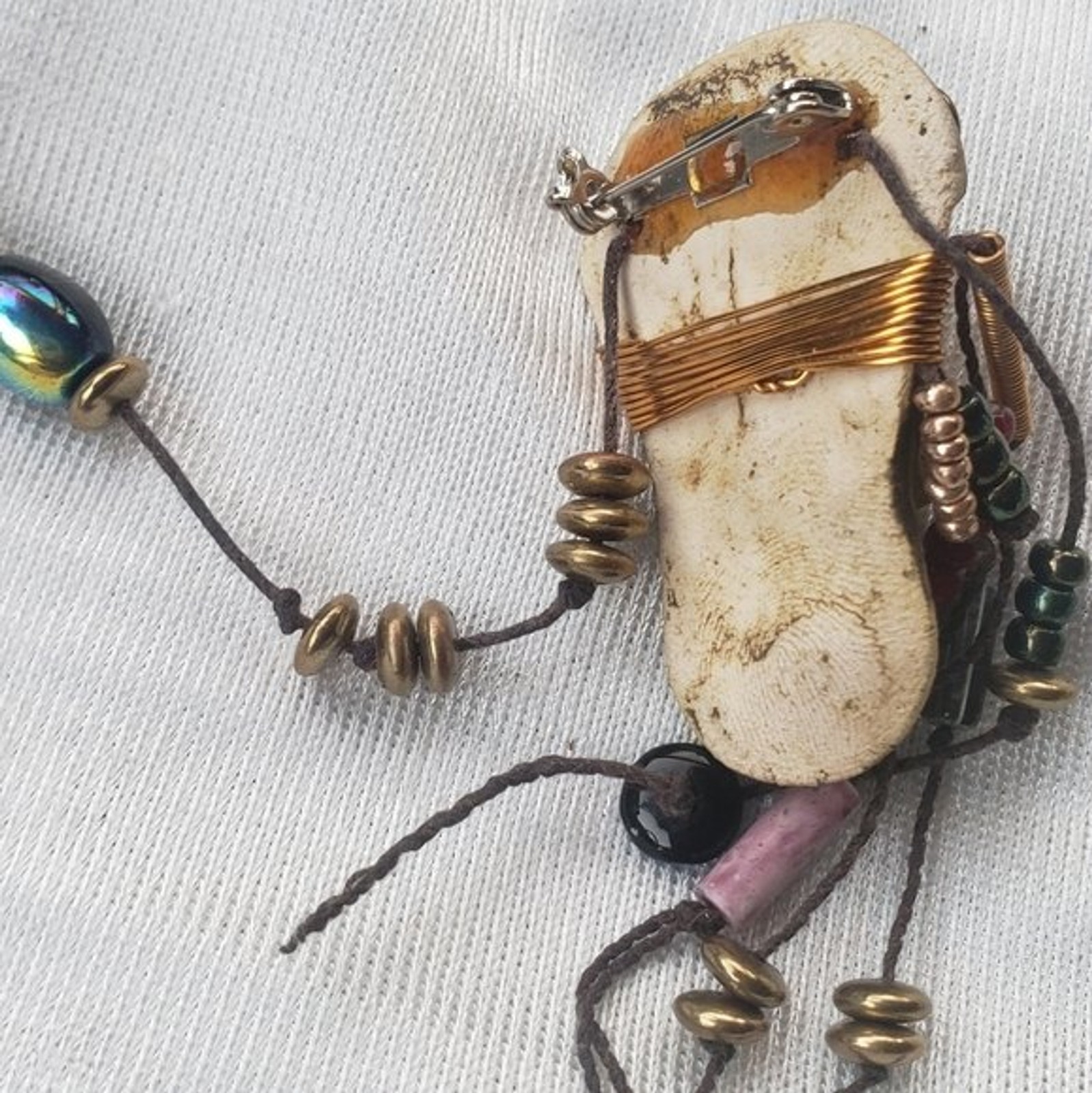 Abstract tribal brutalist face with locs like hair artisan brooch