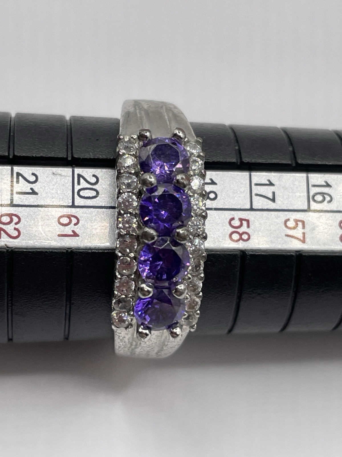 Silver ring with unknown 4 purple stones 10 tiny clear chip stones size 9