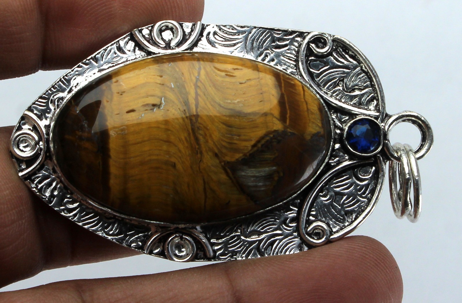 Handcrafted Sterling Silver Natural Tiger’s Eye Pendant – Blue Sapphire Accent
