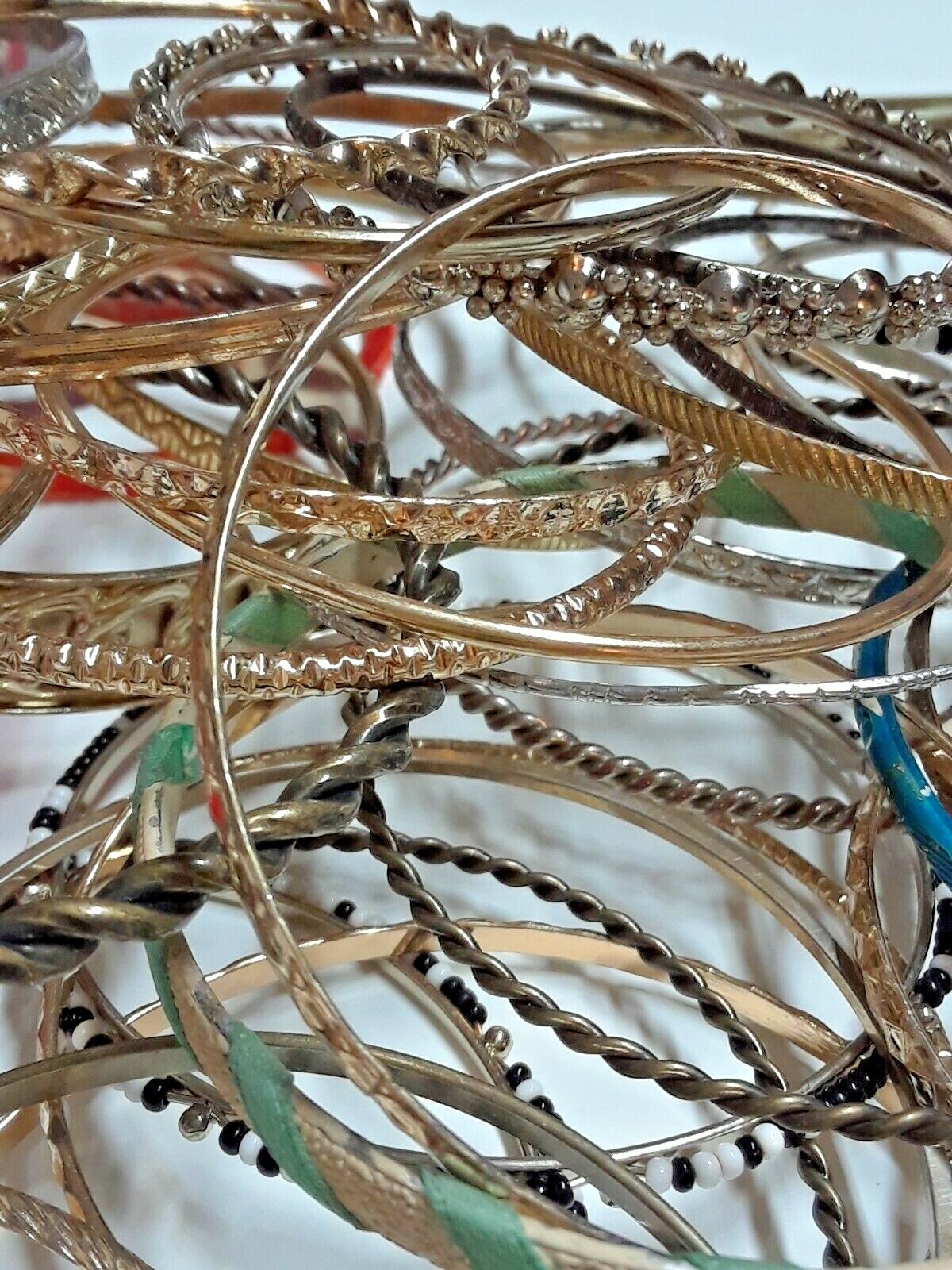 Bangle bracelets. gold tone silver tone, metal, plastic, with patterns. Lot