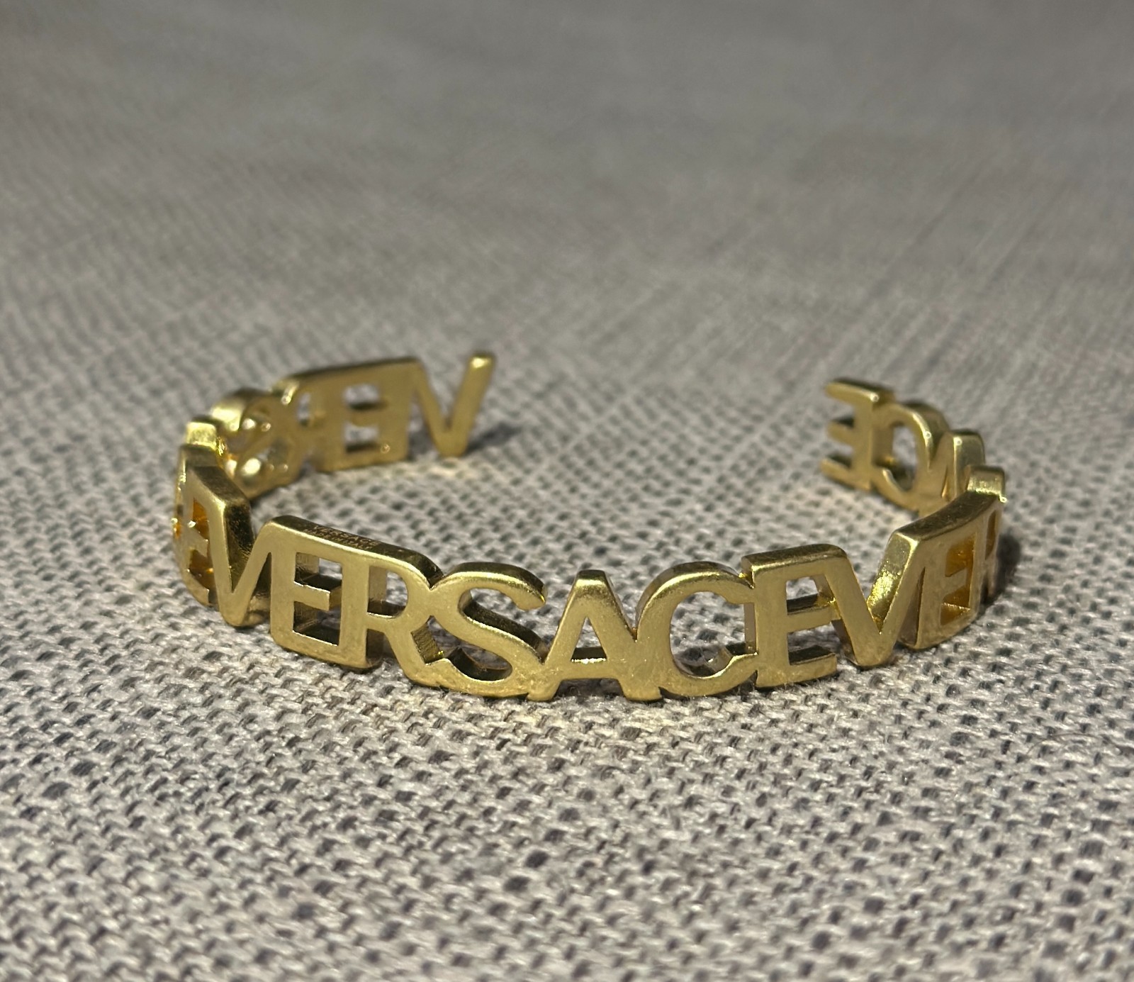 Versace Logo Cuff Bracelet Gold Tone Open Bangle Spellout Designer Luxury