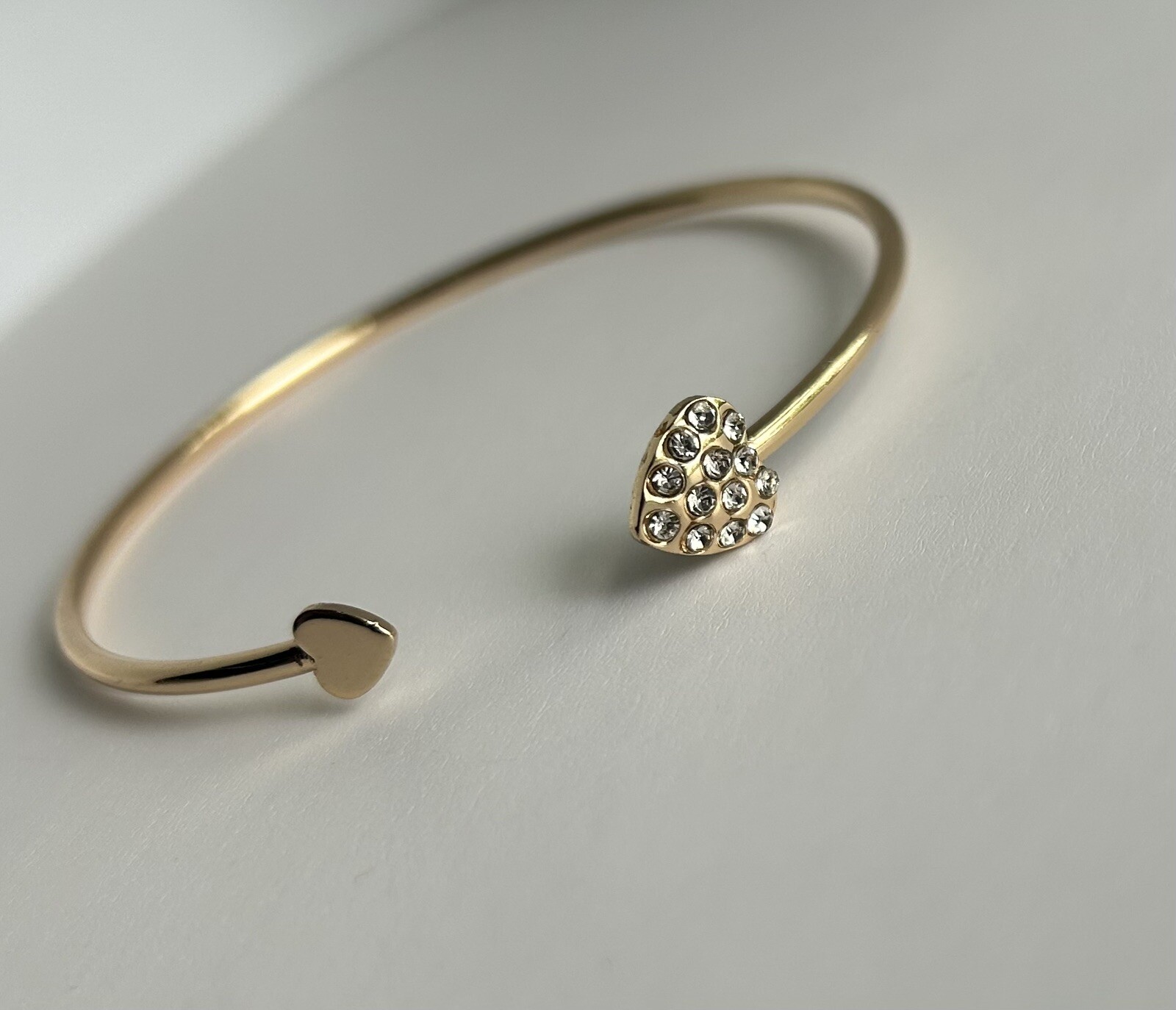 Gold Tone Open Cuff Bracelet (Bangle Style) with CZ Heart Ends