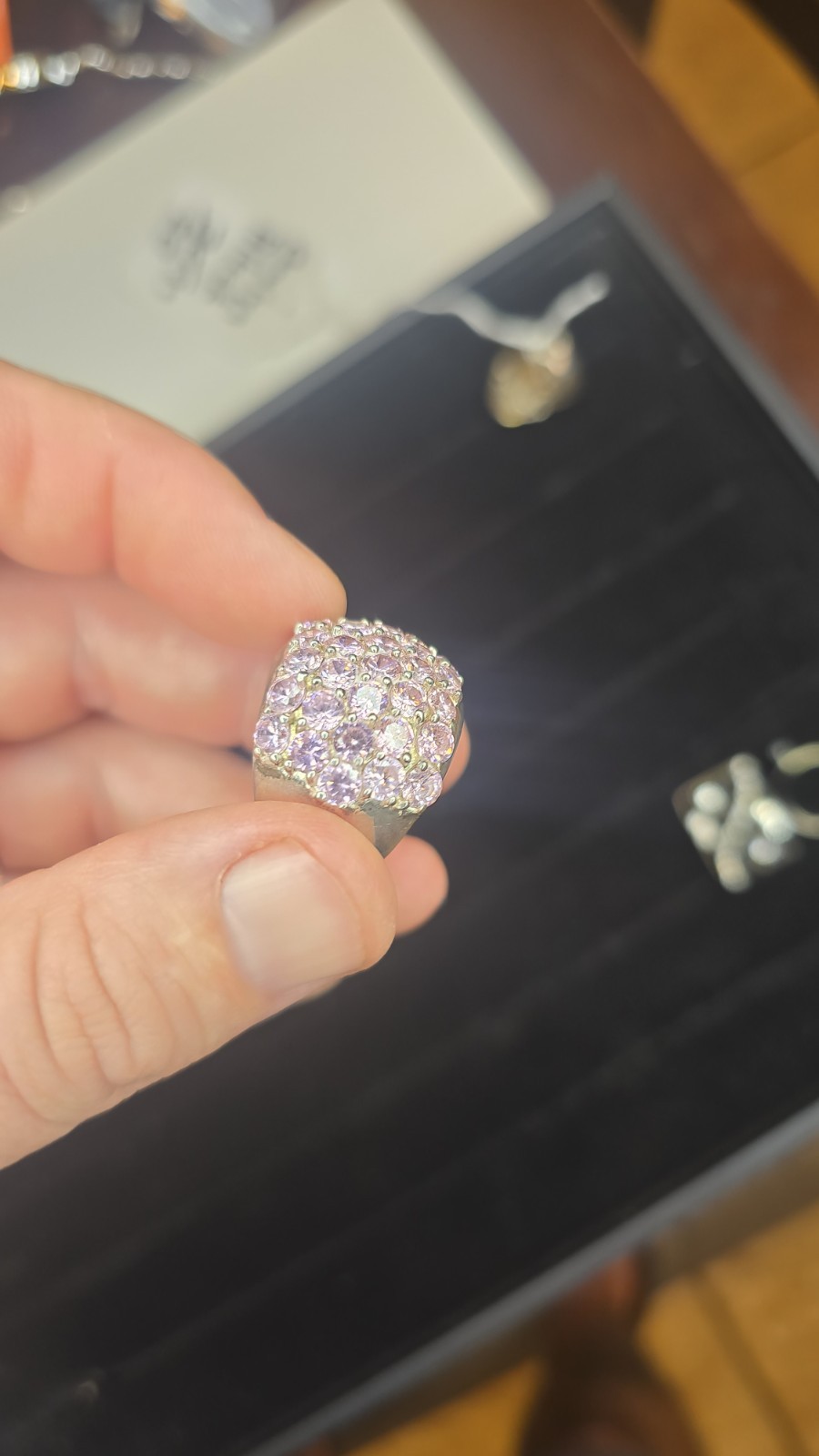 Wide Ring pavé setting of pink gemstones, likely sapphires or cubic zirconia