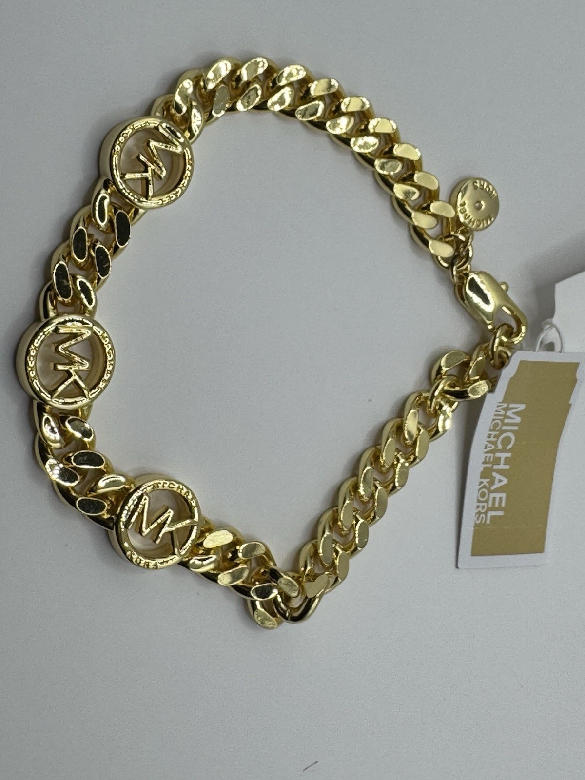 This Michael Kors gold-tone chunky chain bracelet features signature Logo